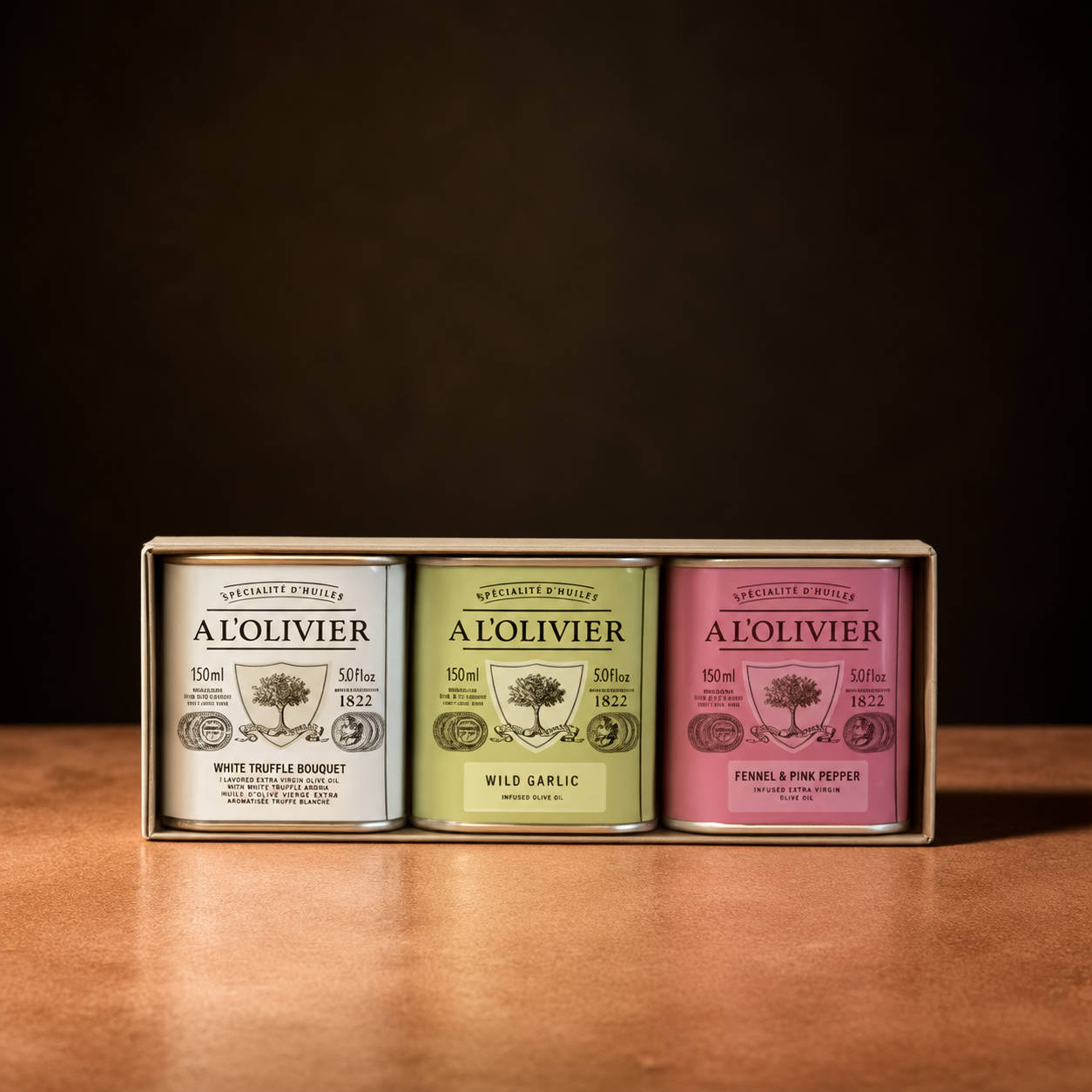 A L'Olivier gift set of three 150ml infused olive oil tins: white truffle, wild garlic, fennel and pink pepper